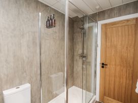A bathroom with a shower and toilet at Pearl Stone House in Whitby