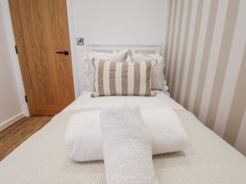 A bedroom with a bed and pillows at Pearl Stone House in Whitby