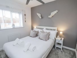A bedroom with a double bed and bedside table at Pearl Stone House in Whitby