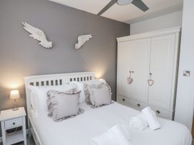 A bedroom with a bed and wardrobe at Pearl Stone House in Whitby