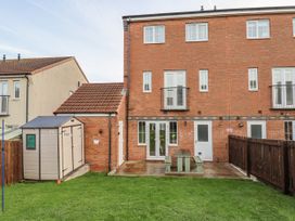 A garden with a shed and patio at Pearl Stone House in Whitby