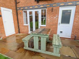 An outdoor area with a table and benches at Pearl Stone House in Whitby