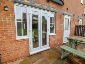 A patio with double doors and a table at Pearl Stone House in Whitby
