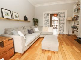 A living room with a sofa and ottoman at 43 Station Road in Keswick