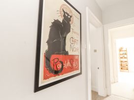 A poster of a cat in a hallway at 43 Station Road Keswick