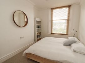 A bedroom with a bed and a mirror at 43 Station Road in Keswick
