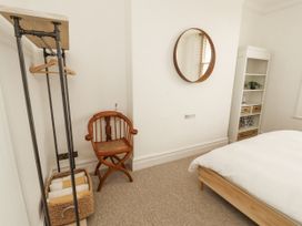 A bedroom with a bed and mirror at 43 Station Road in Keswick