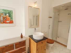 A bathroom with a sink, shower, and toilet at 43 Station Road in Keswick