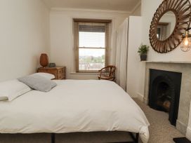 A bedroom with a bed and mirror at 43 Station Road in Keswick