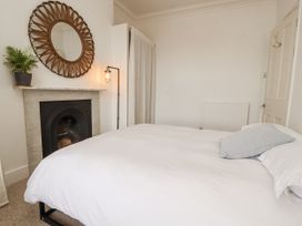 A bedroom with a bed and a fireplace at 43 Station Road in Keswick