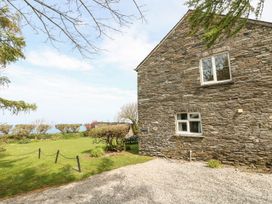 The exterior of a stone house with a garden at Tremorla in Boscastle