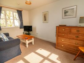 A living room with a sofa and television at Tremorla in Boscastle