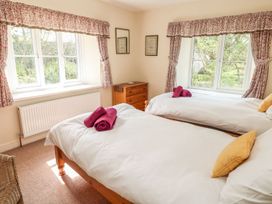 A bedroom with two beds and a dresser at Tremorla in Boscastle