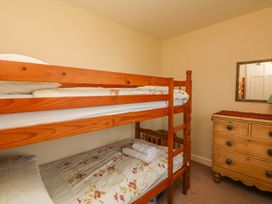 A bedroom with a bunk bed and dresser at Tremorla in Boscastle