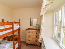 A bedroom with a bunk bed and a chest of drawers at Tremorla in Boscastle