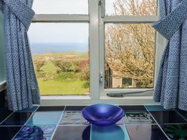 A kitchen window with a bowl and view at Tremorla in Boscastle