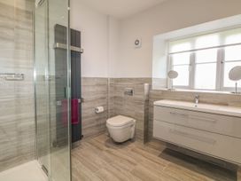 A bathroom with shower, toilet, and vanity unit at Tremorla in Boscastle