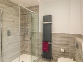 A bathroom with a shower and towel heater at Tremorla in Boscastle