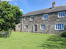 An outdoor view of a stone house with a garden at Tremorla in Boscastle