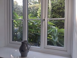 A window view with plants and a vase at Tremorla in Boscastle