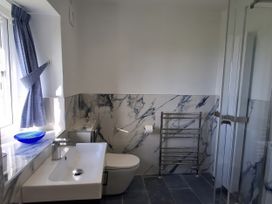 A bathroom with a sink, toilet, and shower at Tremorla in Boscastle