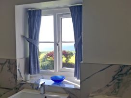 A bathroom with a window and a sink at Tremorla in Boscastle