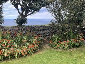 A garden with flowers and a stone wall at Tremorla in Boscastle