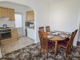 A dining room with a table and chairs at No.1 Vanderhoof Way Saundersfoot