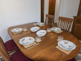 A dining room with a table set for six at No.1 Vanderhoof Way Saundersfoot