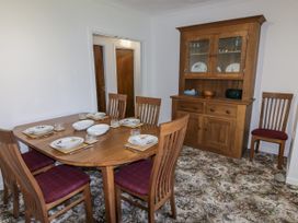 A dining room with a table set for meals at No.1 Vanderhoof Way Saundersfoot