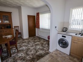 A dining room with a table and chairs at No.1 Vanderhoof Way Saundersfoot
