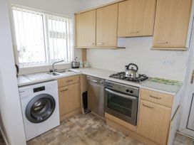 A kitchen with a sink and appliances at No.1 Vanderhoof Way Saundersfoot