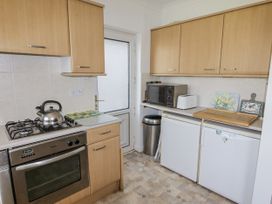 A kitchen with cabinets, a gas cooker, and appliances at No.1 Vanderhoof Way Saundersfoot