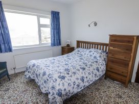 A bedroom with a bed and dresser at No.1 Vanderhoof Way Saundersfoot