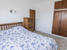 A bedroom with a bed and wardrobe at No.1 Vanderhoof Way Saundersfoot