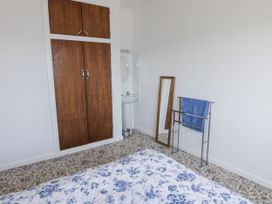 A bedroom with a bed and a wardrobe at No.1 Vanderhoof Way Saundersfoot