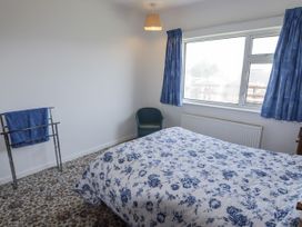 A bedroom with a bed and a window at No.1 Vanderhoof Way Saundersfoot