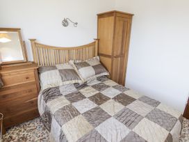 A bedroom with a bed and dresser at No.1 Vanderhoof Way Saundersfoot