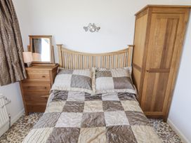 A bedroom with a bed and furniture at No.1 Vanderhoof Way Saundersfoot