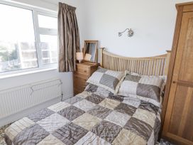 A bedroom with a bed and window at No.1 Vanderhoof Way Saundersfoot