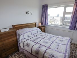 A bedroom with a bed and window at No.1 Vanderhoof Way Saundersfoot