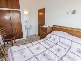 A bedroom with a bed and wardrobe at No.1 Vanderhoof Way in Saundersfoot