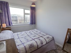 A bedroom with a bed and lamp at No.1 Vanderhoof Way Saundersfoot
