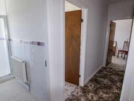A hallway with a radiator and a shower door at No.1 Vanderhoof Way Saundersfoot