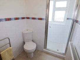 A bathroom with a toilet and shower at No.1 Vanderhoof Way Saundersfoot