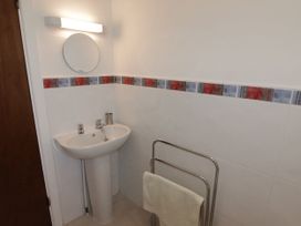 A bathroom with a sink and towel rack at No.1 Vanderhoof Way in Saundersfoot