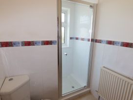 A bathroom with a shower and toilet at No.1 Vanderhoof Way in Saundersfoot