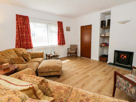A living room with a sofa and fireplace at No.1 Vanderhoof Way in Saundersfoot