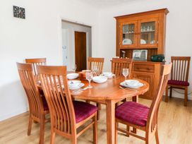 A dining room with a table set for meals at No.1 Vanderhoof Way Saundersfoot