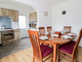 A dining room with a table and chairs at No.1 Vanderhoof Way, Saundersfoot